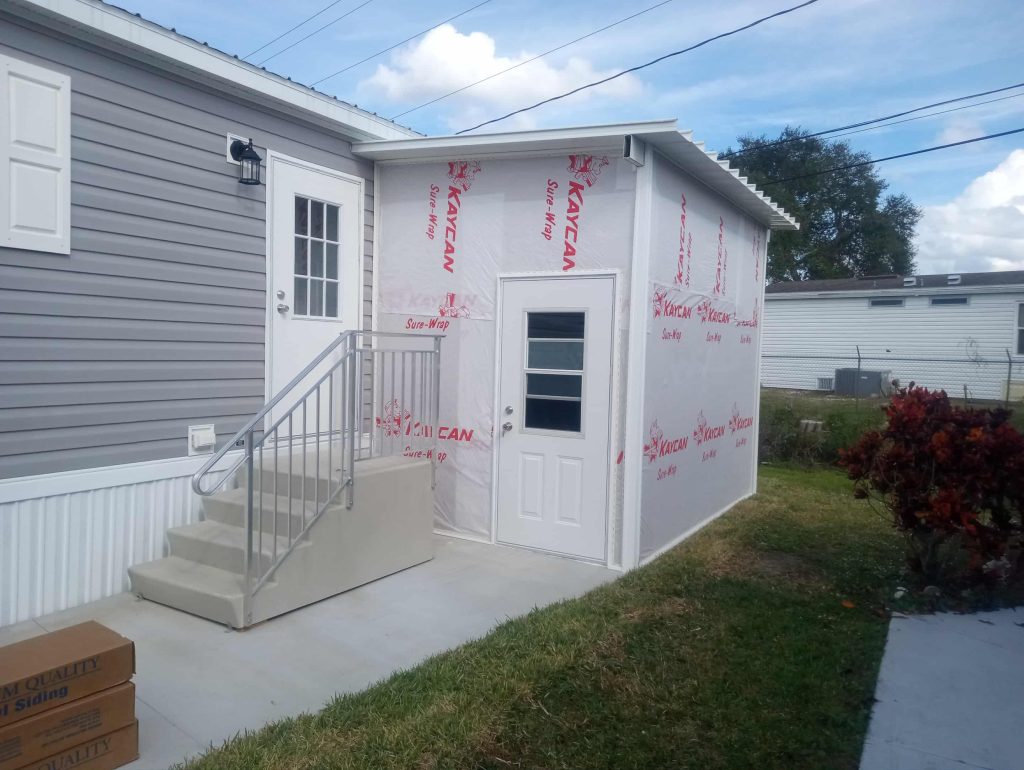 Close-up of aluminum pan roof installation on wood frame shed in Cocoa Florida