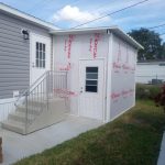 Close-up of aluminum pan roof installation on wood frame shed in Cocoa Florida