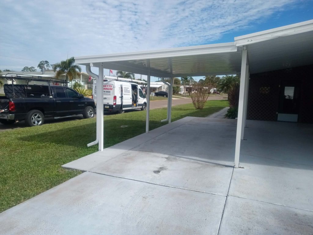 Aluminum carport addition attached to existing structure on modular home in Titusville