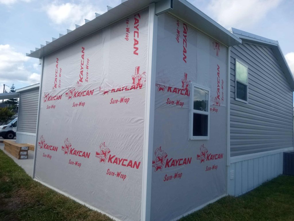 Wood frame shed with aluminum pan roof built alongside modular home in Cocoa Florida