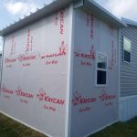 Wood frame shed with aluminum pan roof built alongside modular home in Cocoa Florida