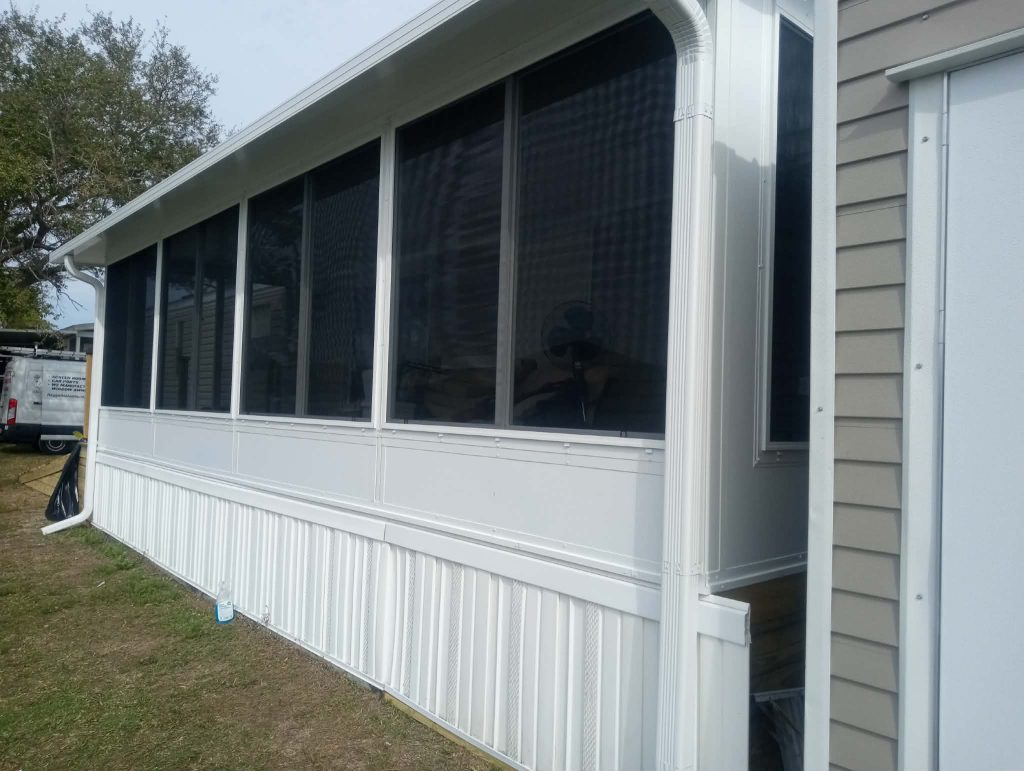 White aluminum Florida room with insulated roof and windows on waterfront property in Central Florida