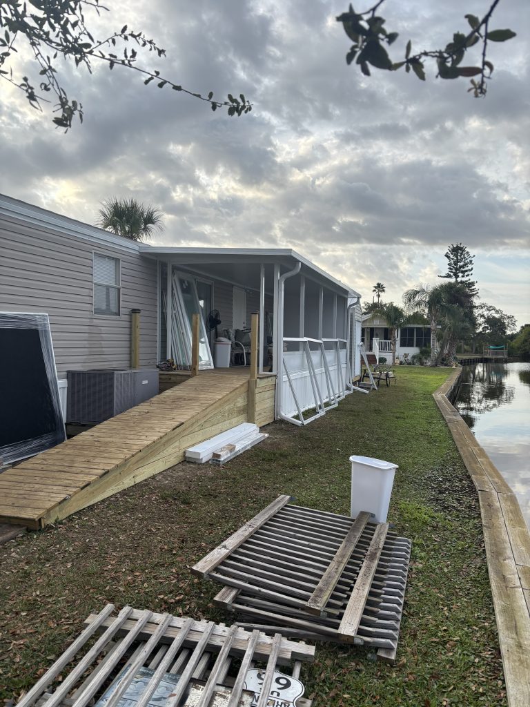 Construction progress of Florida room showing aluminum framework and wood deck foundation