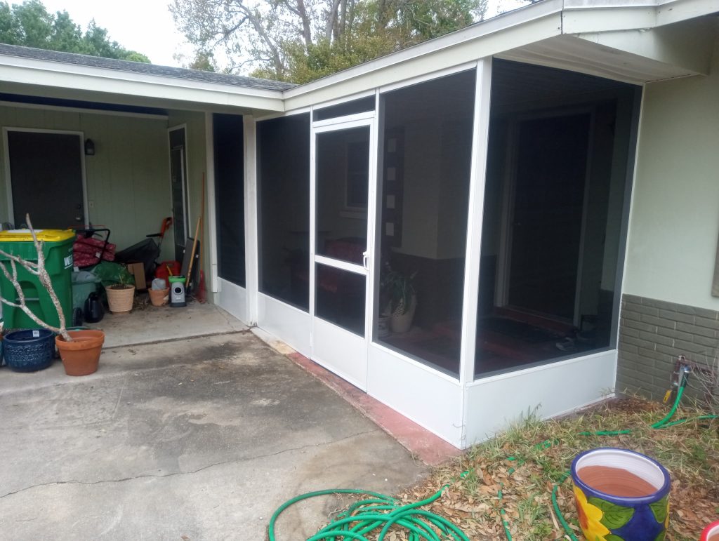 Screened entryway enclosure framed under existing house roof in Central Florida