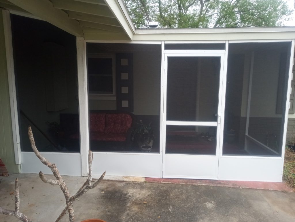 Screened entryway enclosure framed under existing house roof in Central Florida