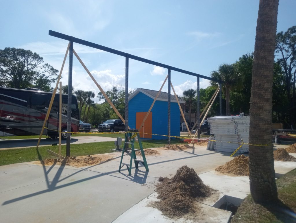 Early construction of large freestanding aluminum motorhome carport in Titusville Florida