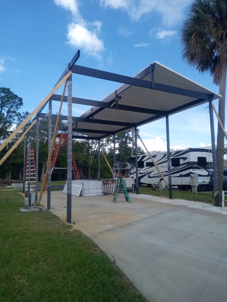 Aluminum motorhome carport with insulated roof panels going up in Titusville