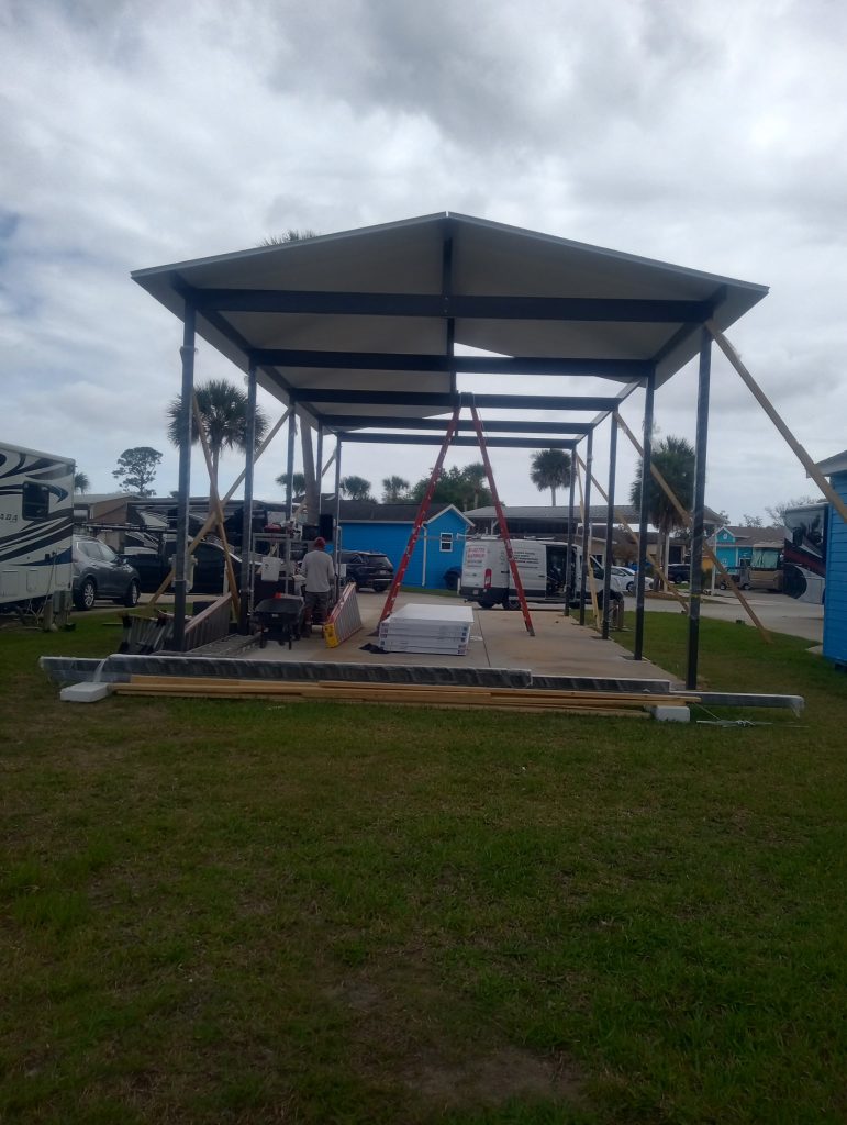 Almost completed freestanding 22 by 42 foot motorhome carport with insulated roof in Titusville Florida