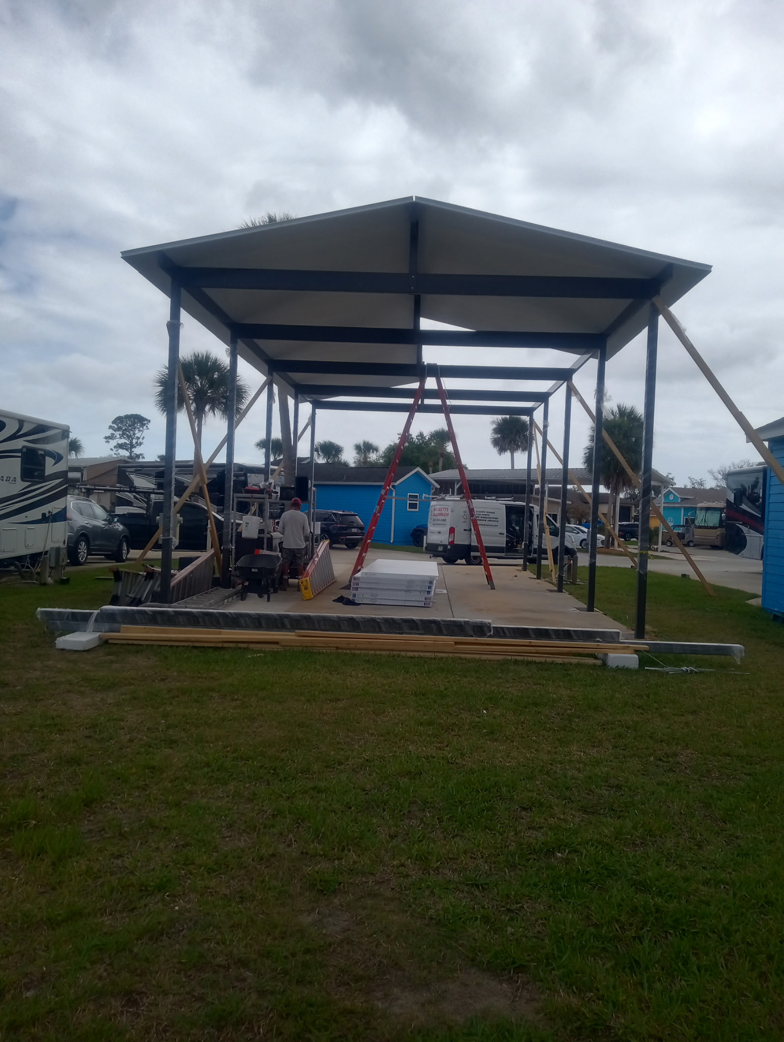 Aluminum motorhome carport with insulated roof panels going up in Titusville