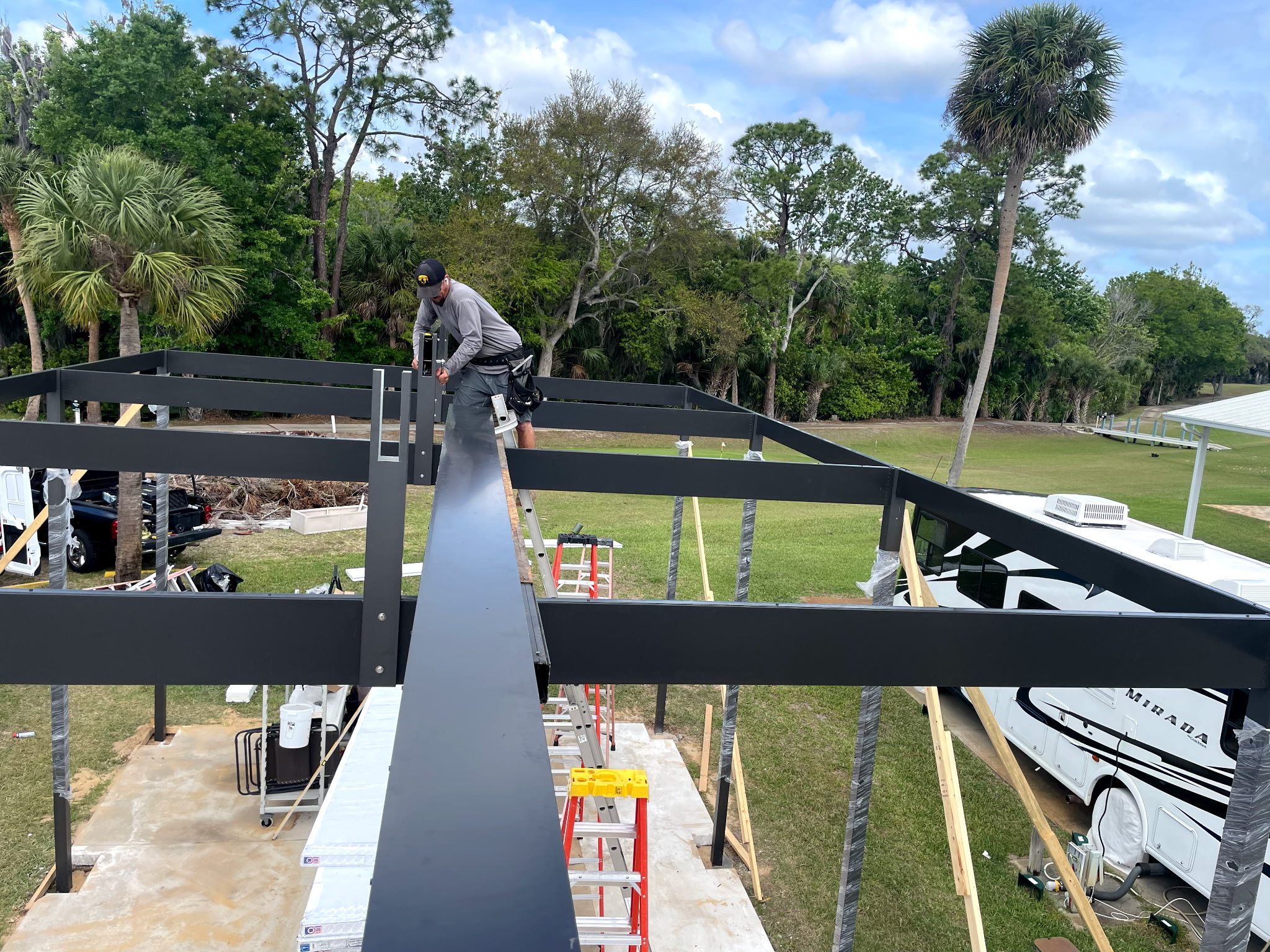 Completed freestanding 22 by 42 foot motorhome carport with insulated roof in Titusville Florida