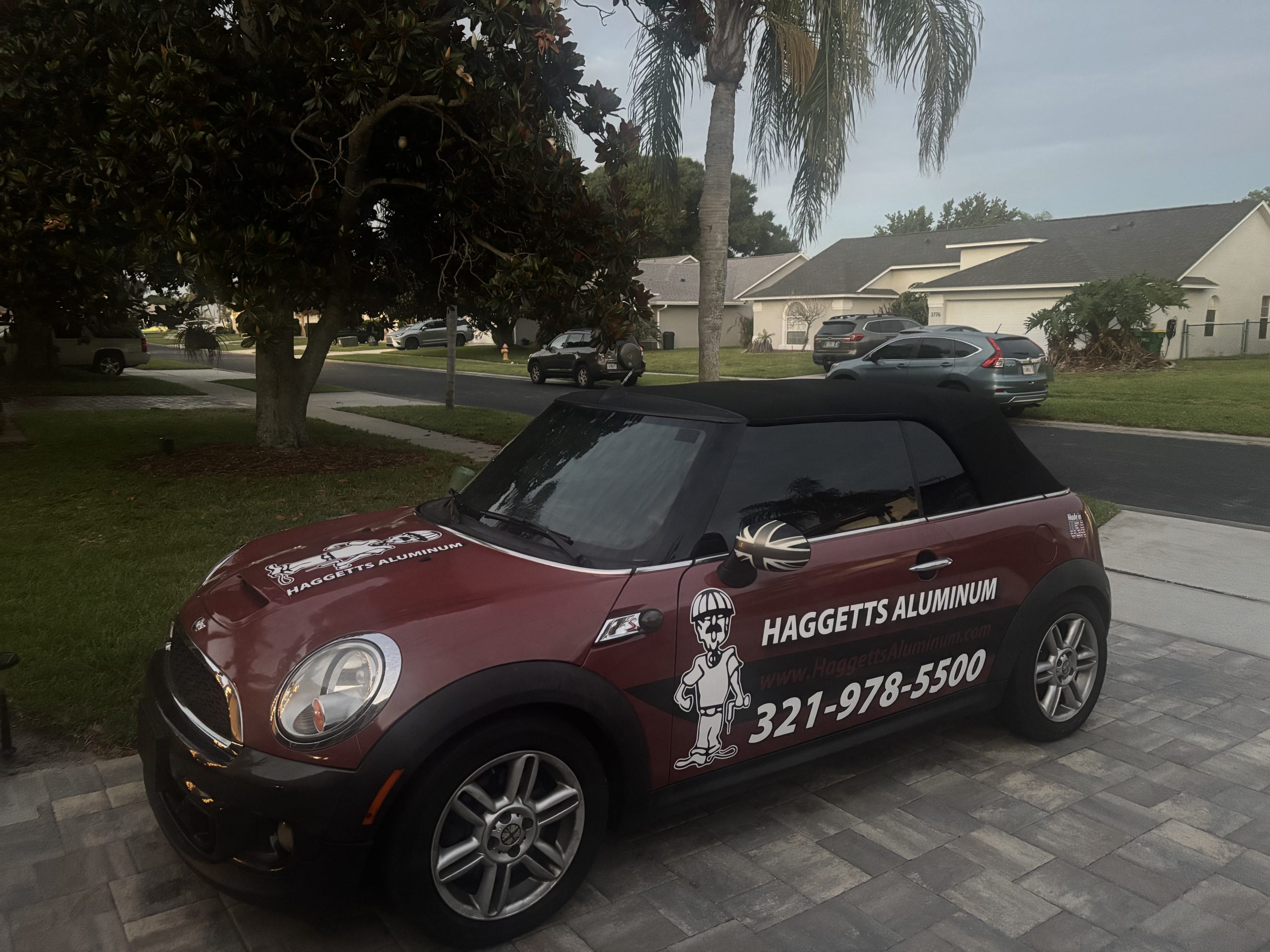 Rear view of the Haggetts Aluminum company Mini Cooper at sunset