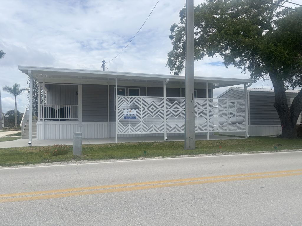 Small white aluminum pan roof cover installed over a home's back door in Central Florida to keep the entry dry during rain