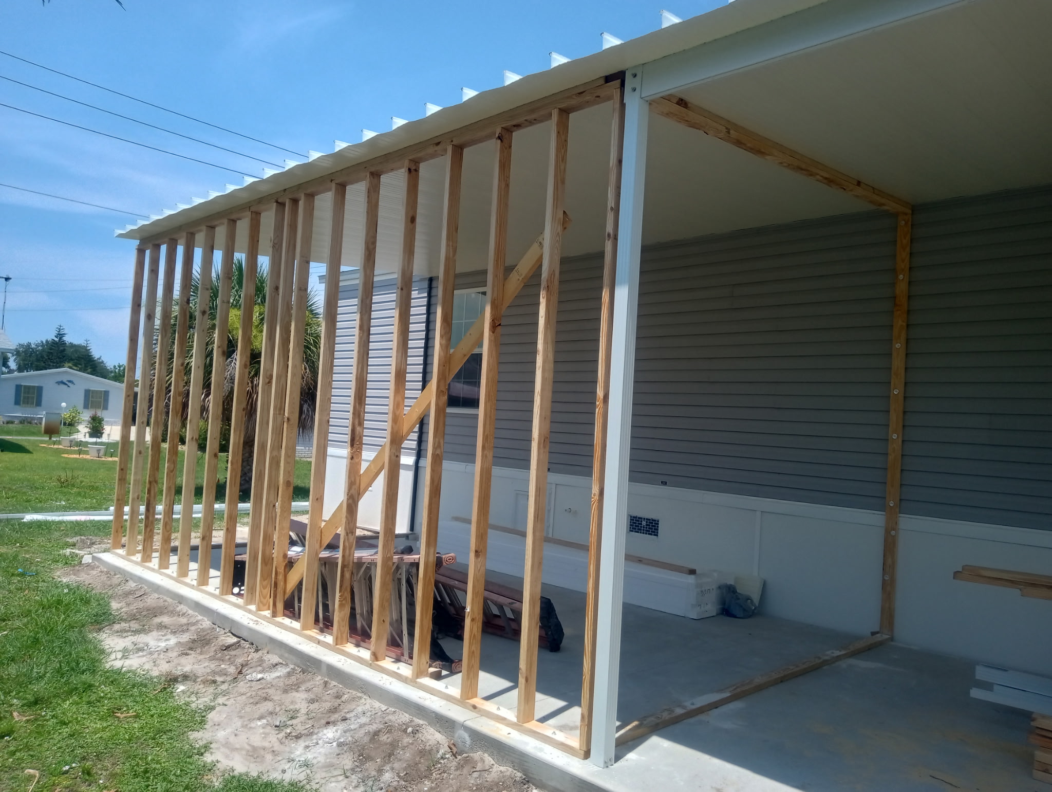 Ground work underway for new shed, Florida room, and carport addition on manufactured home in Barefoot Bay Florida