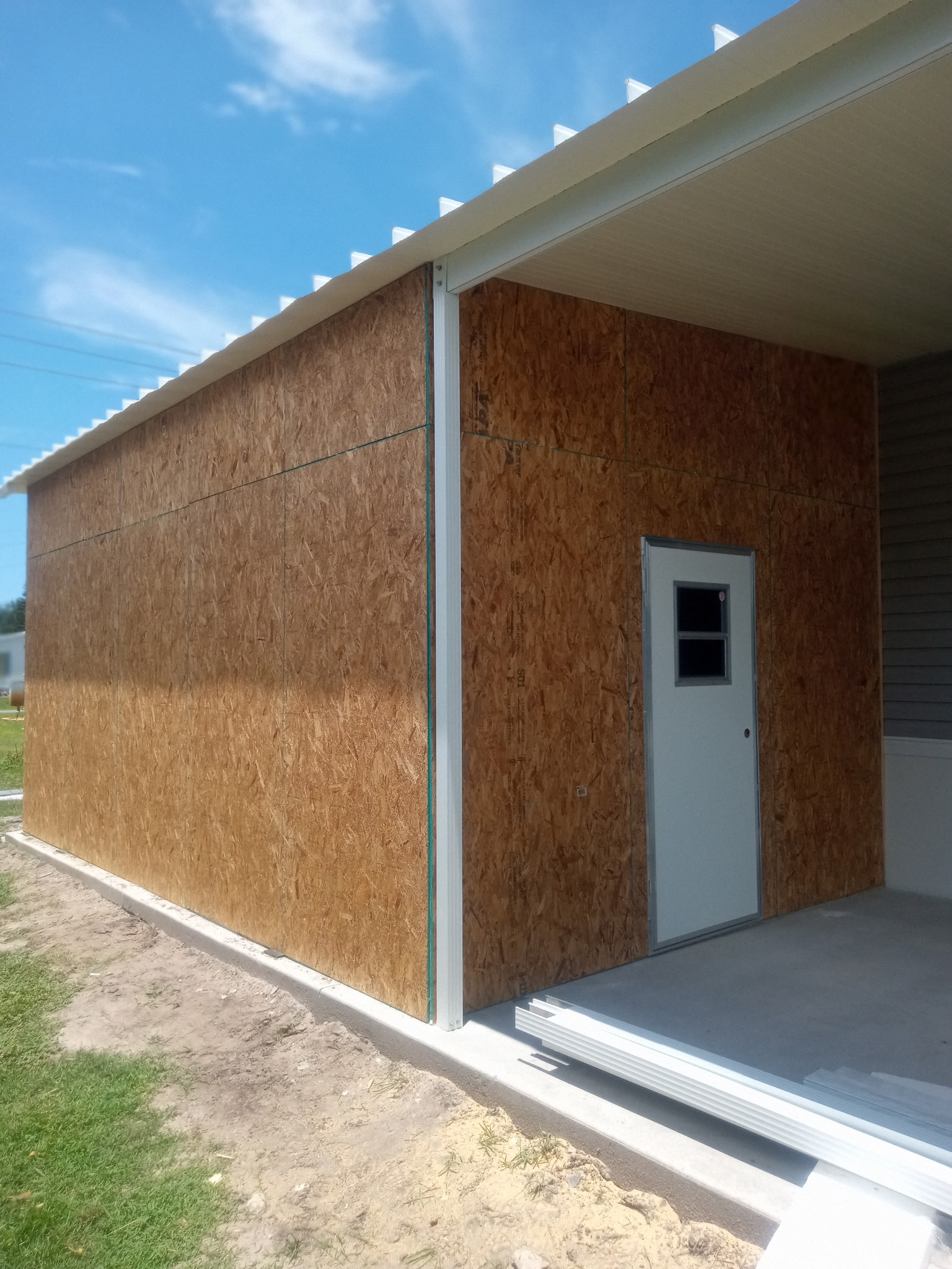 Florida room framing with glass sliding window openings under construction in Barefoot Bay