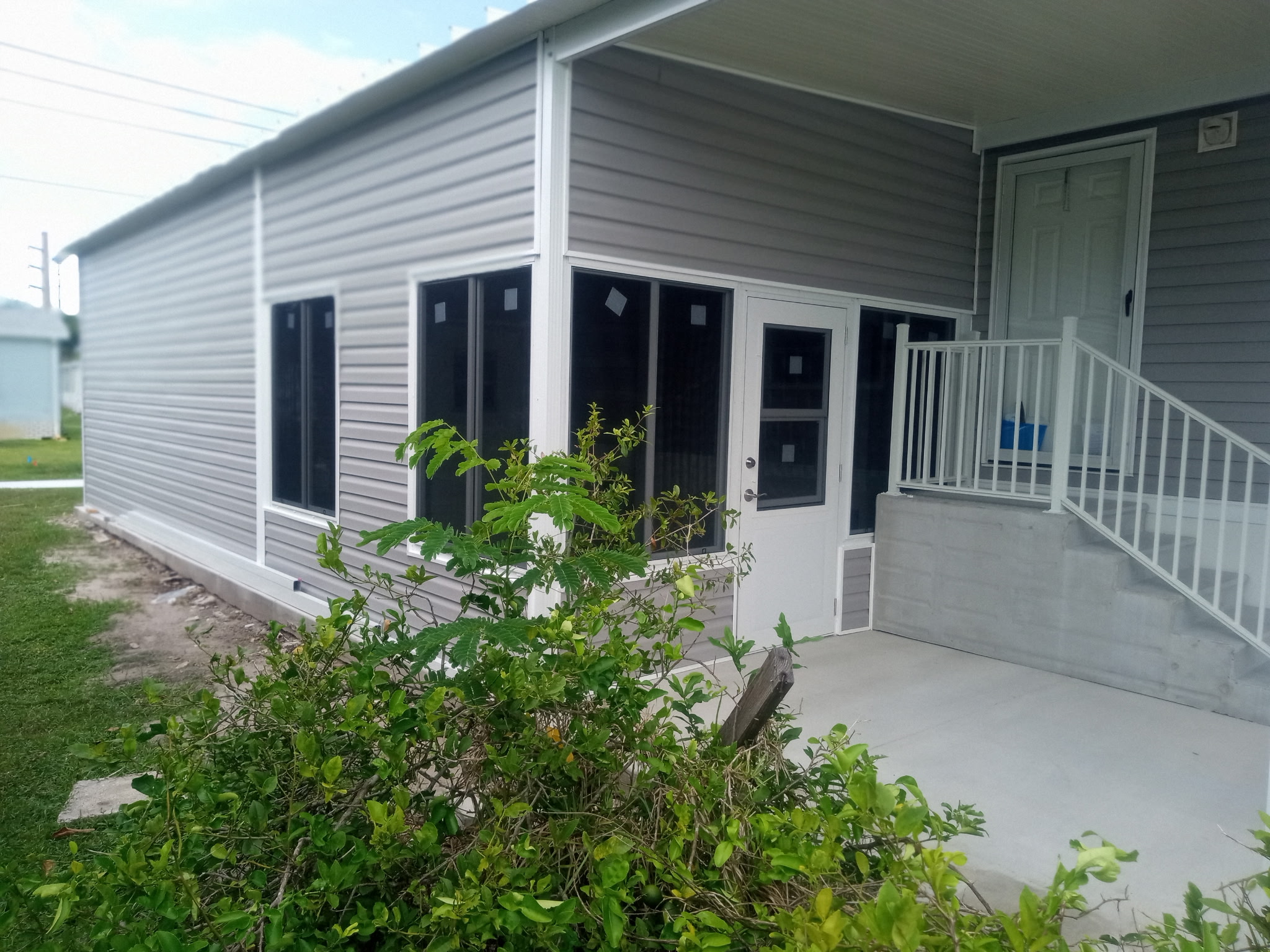 Finished aluminum construction on shed Florida room and carport at manufactured home in Barefoot Bay Florida